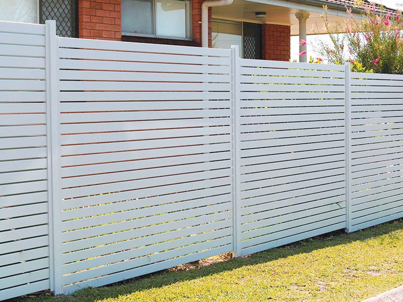 White aluminium slat fence surrounding a residential property